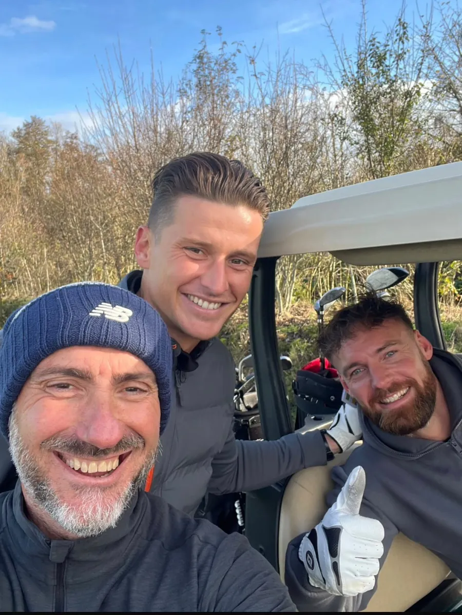 Pedro Nogueira with fellow golfers on the course, smiling after a round